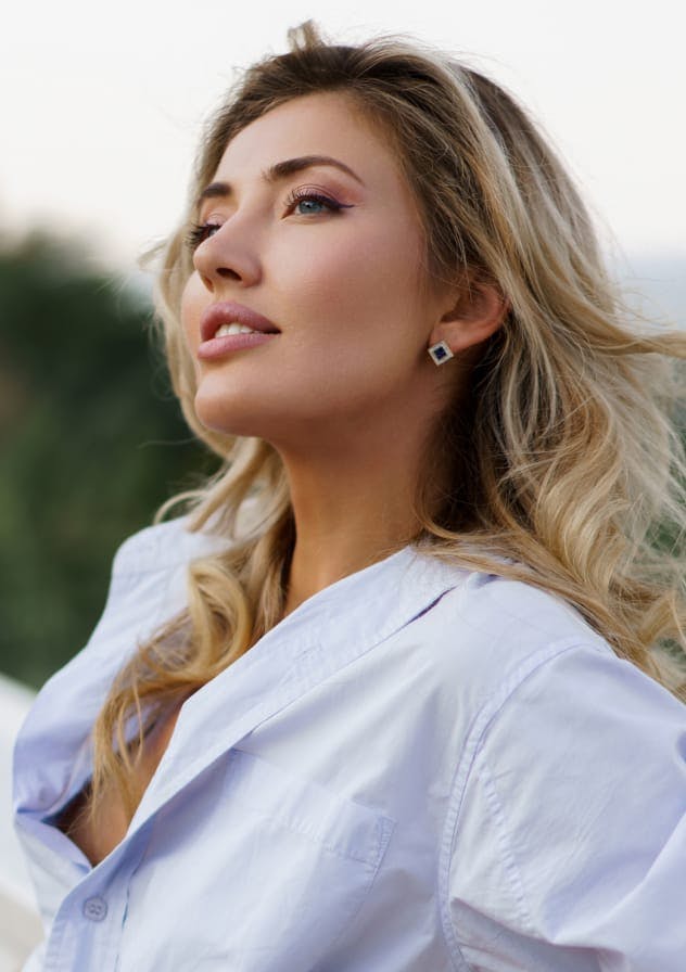 Smiling woman outdoors used as category card for Injectables