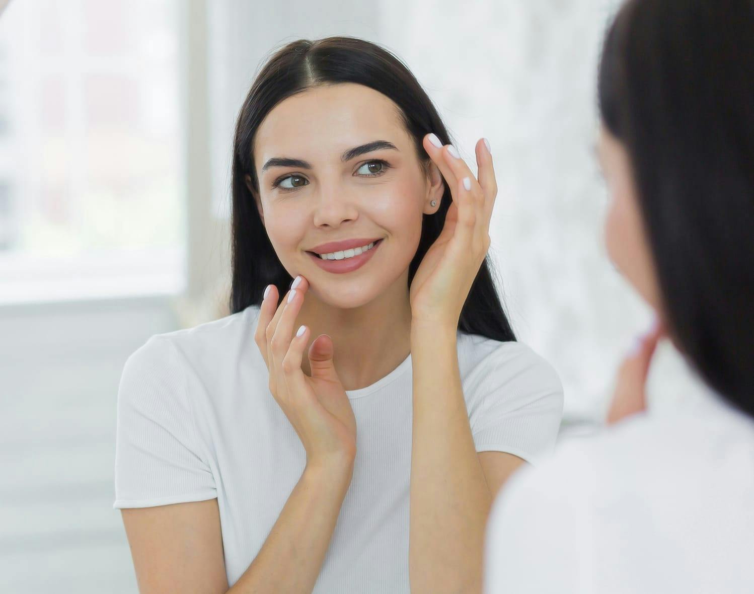 woman looking at herself in the mirror