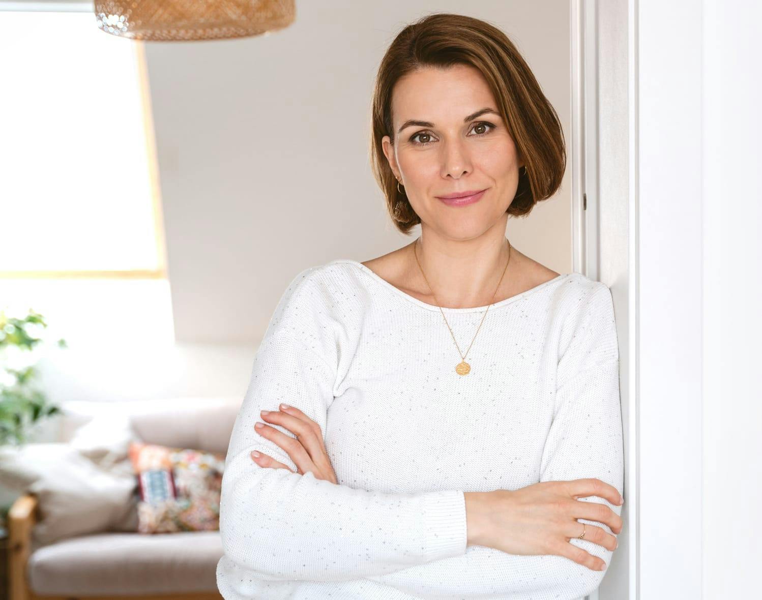 woman leaning against a door jam