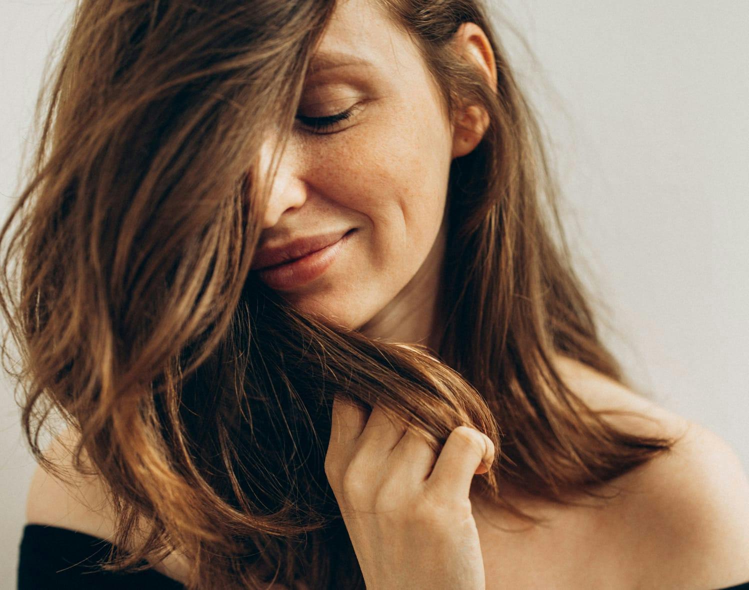 woman touching her hair