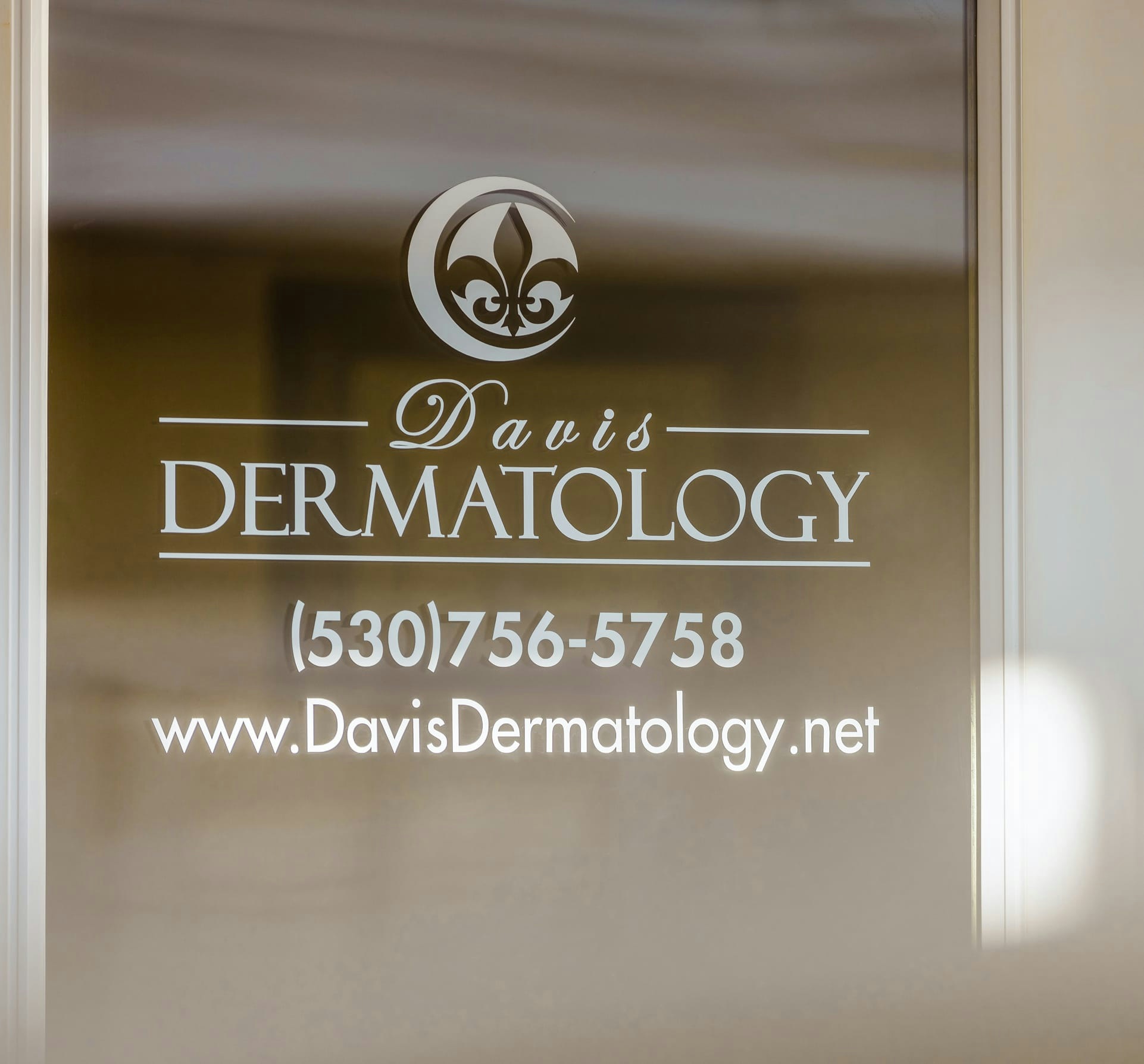 Davis Dermatology logo on a door
