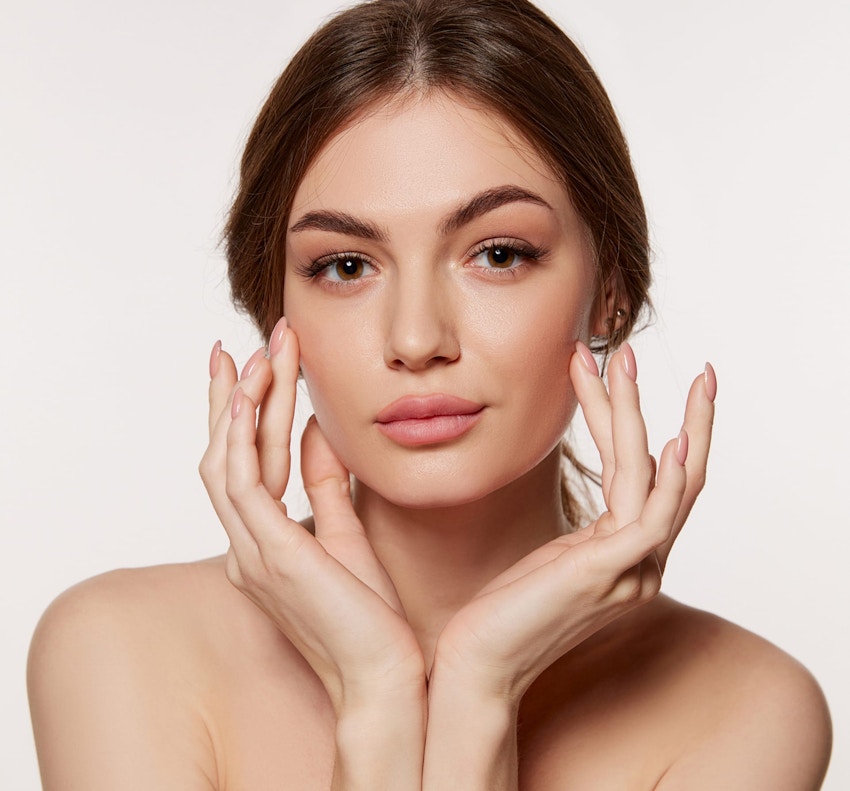 woman touching her face