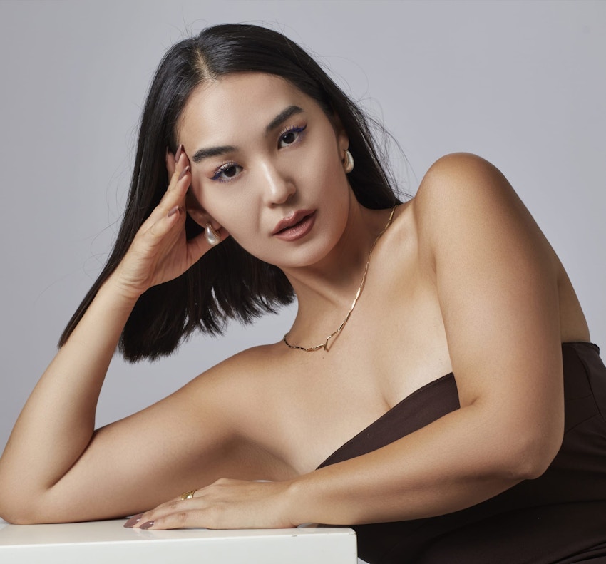 woman leaning over a table