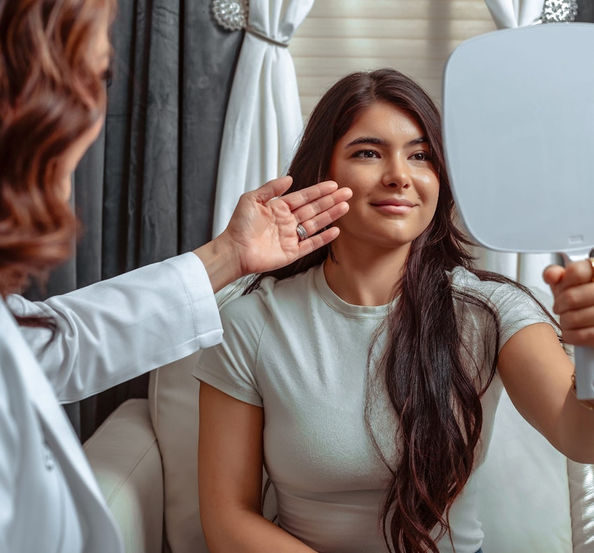 woman looking into a mirror