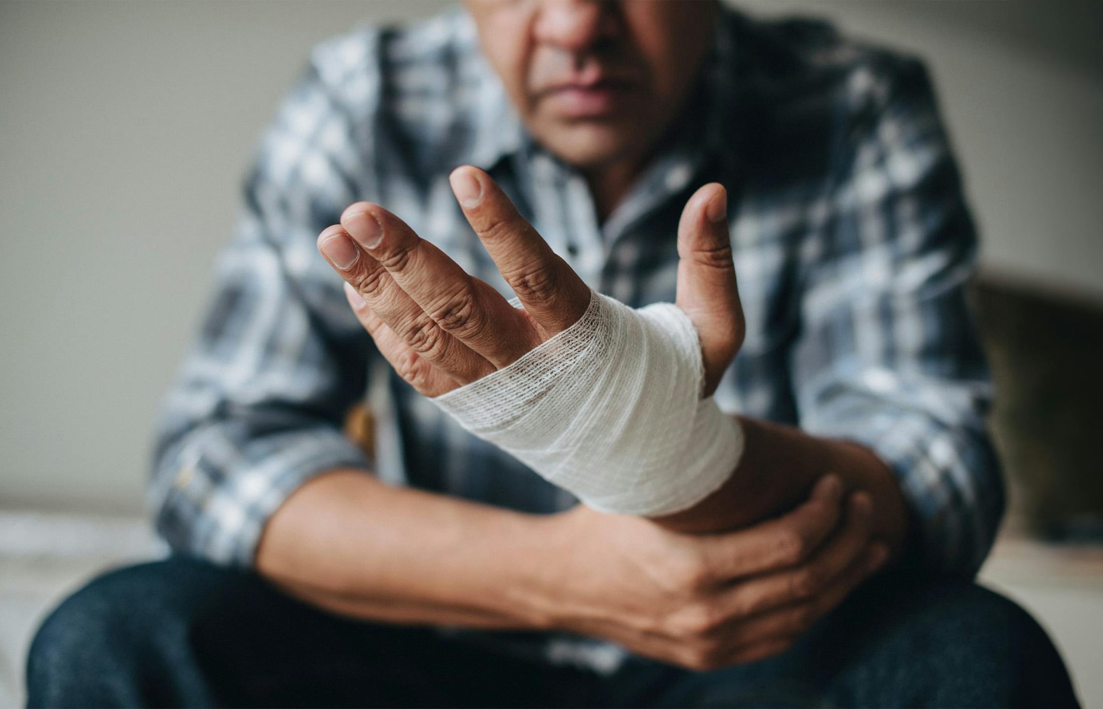 Man with his hand bandaged