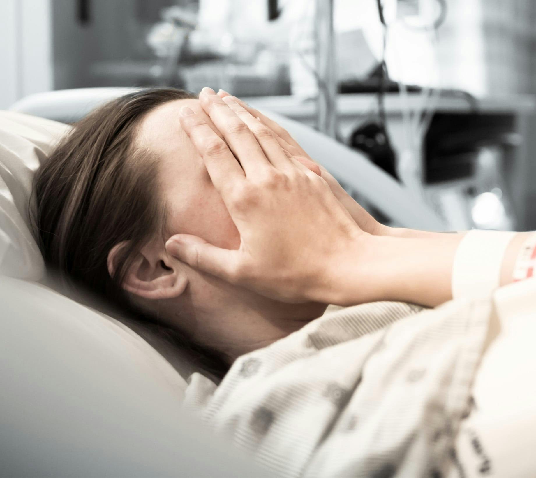 Woman lying in hospital bed