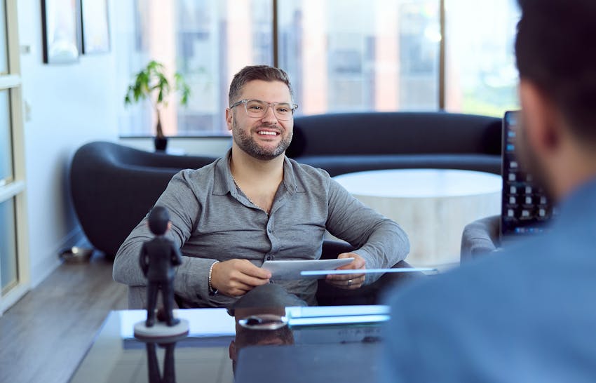 A client holding paperwork smiling