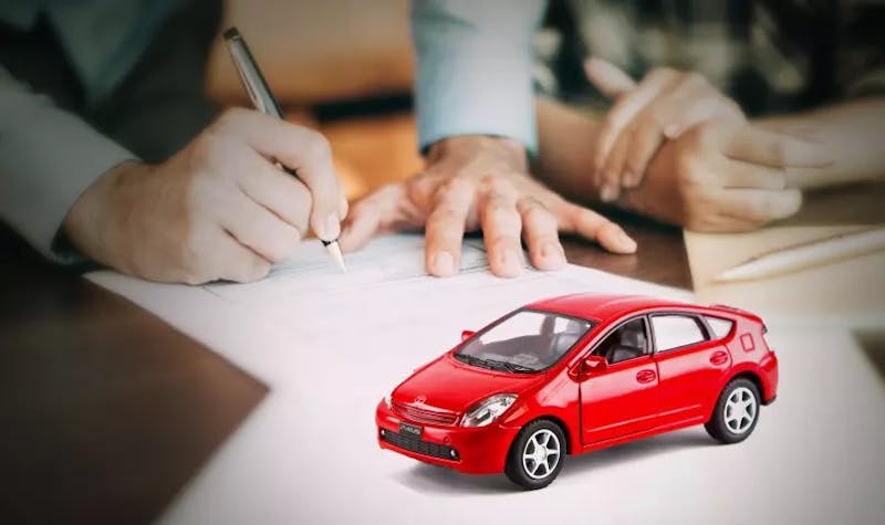 A red toy car on desk