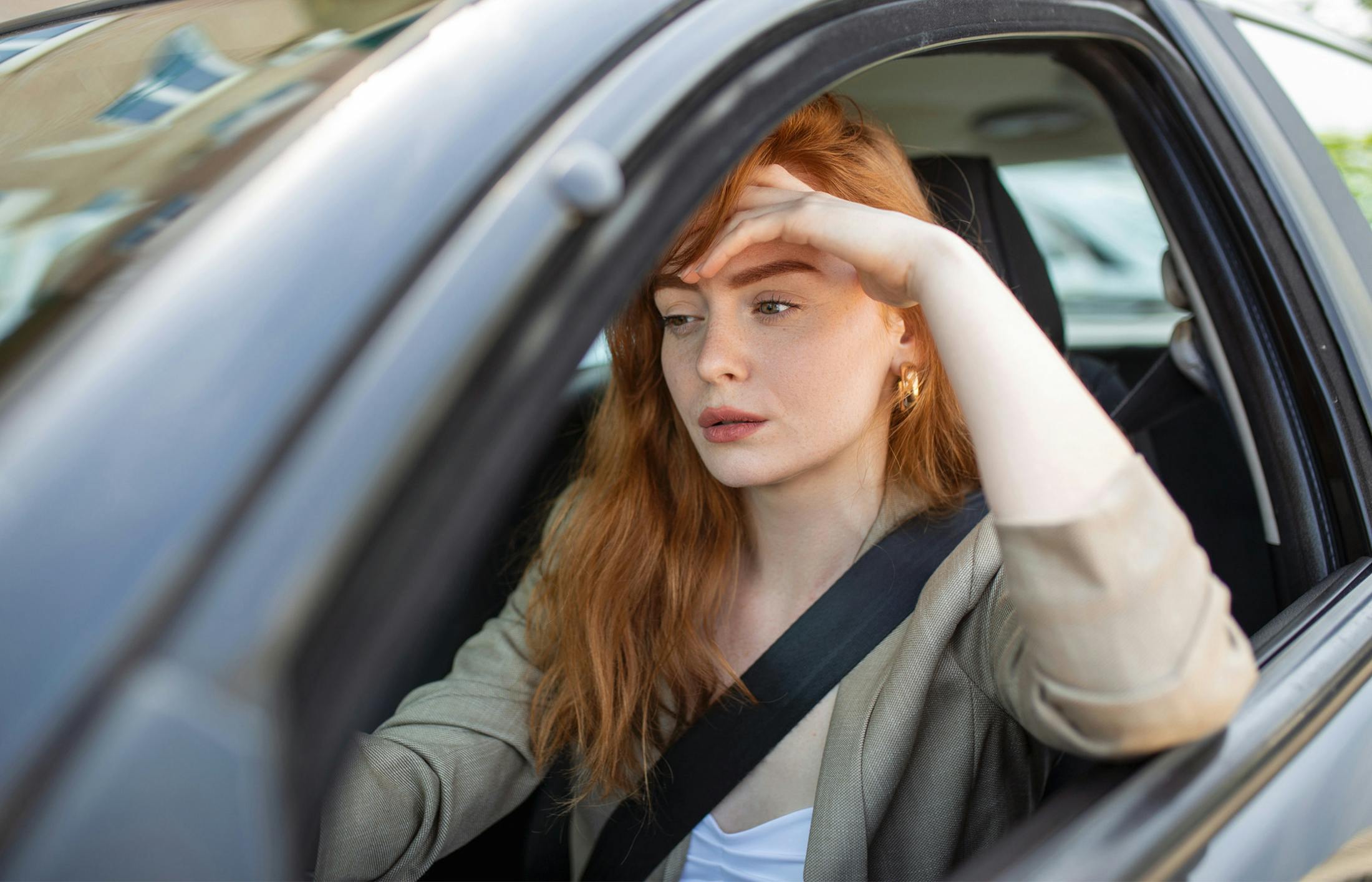 Distressed woman sitting in her car