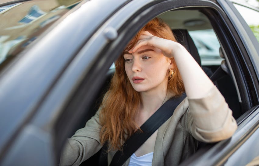 Distressed woman sitting in her car