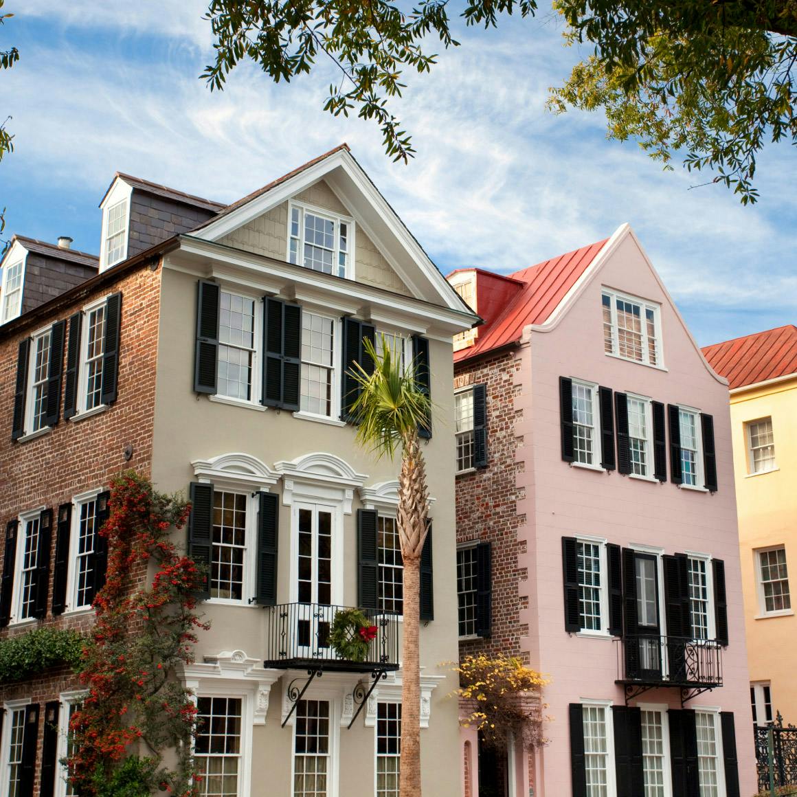 2 colorful three-story townhomes next to eachother