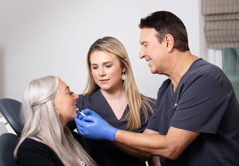 John Rick looking at female patient's teet