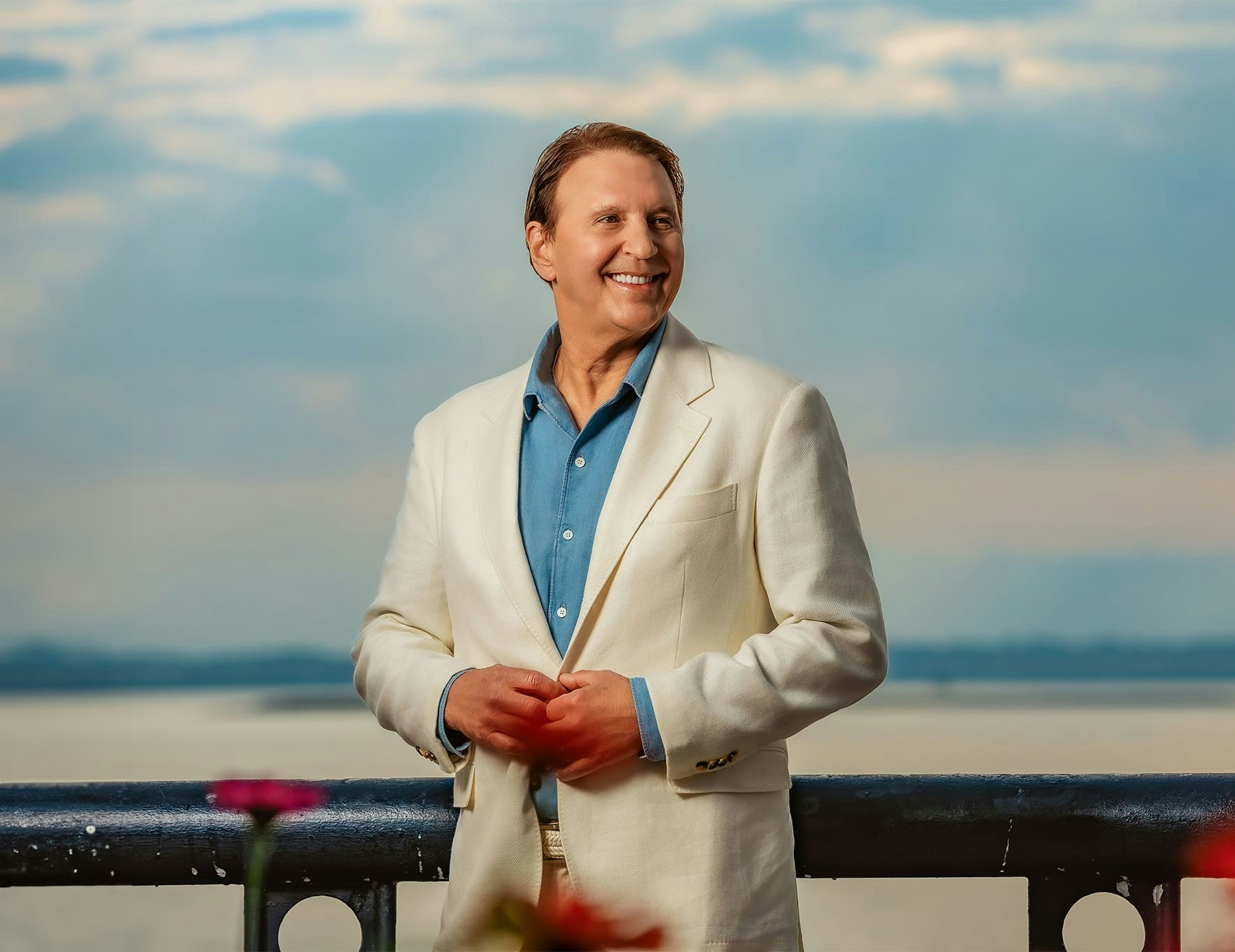 Dr. John Rink in white suit smiling