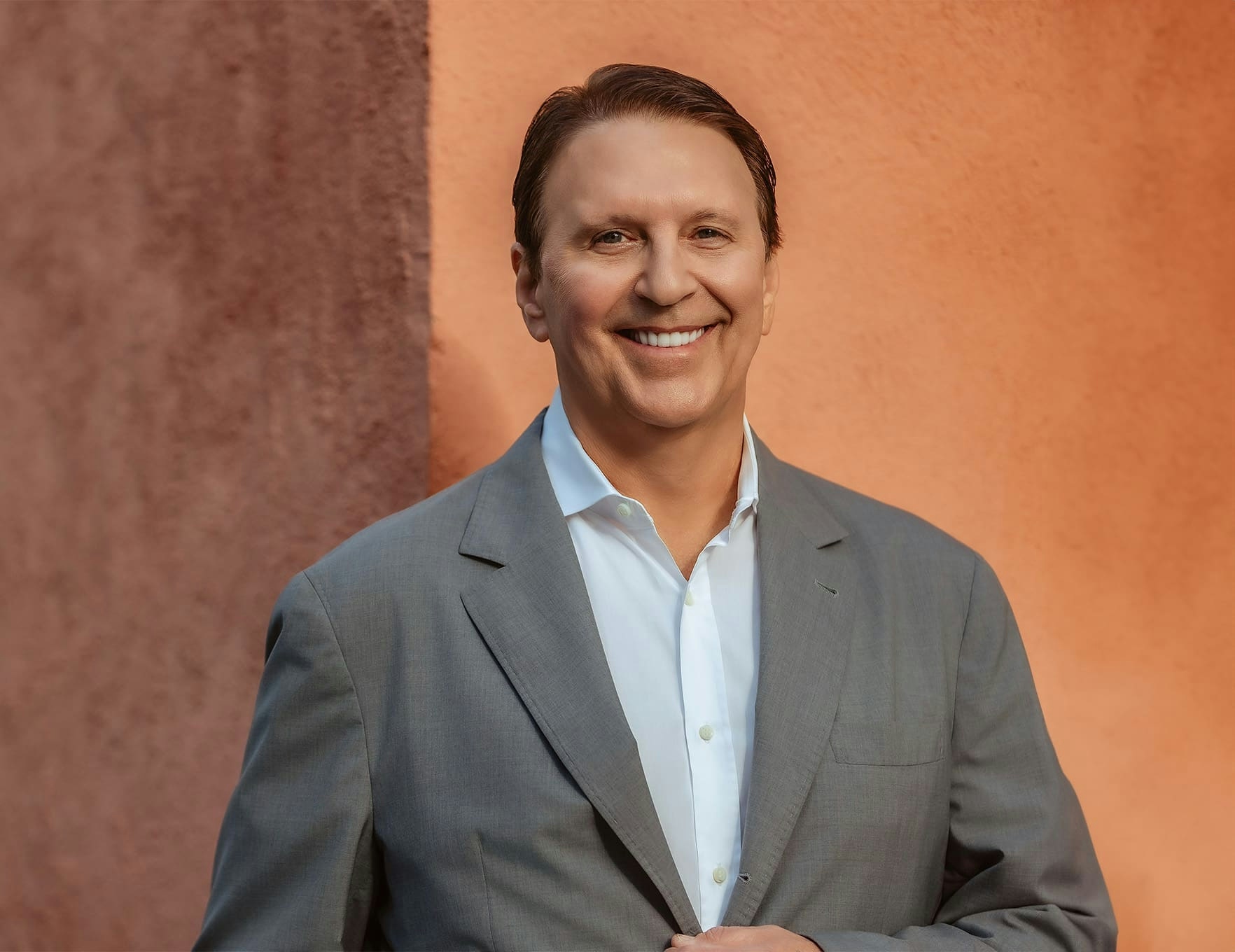 Dr. John Rink in gray suit smiling