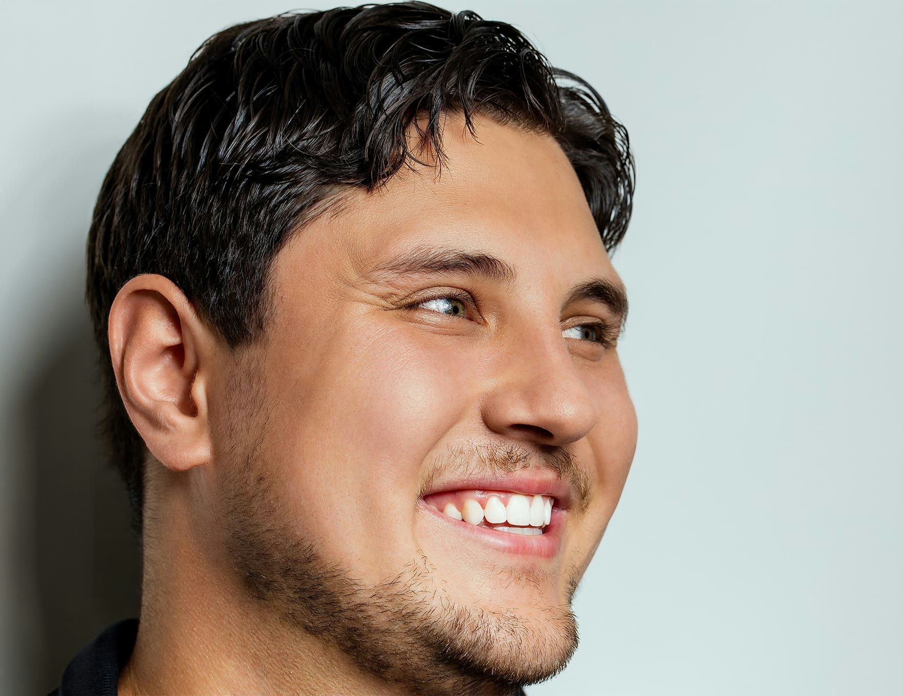 man smiling and looking to the right