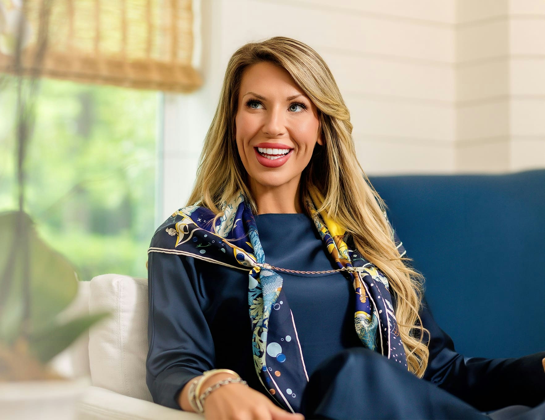 woman sitting on couch smiling