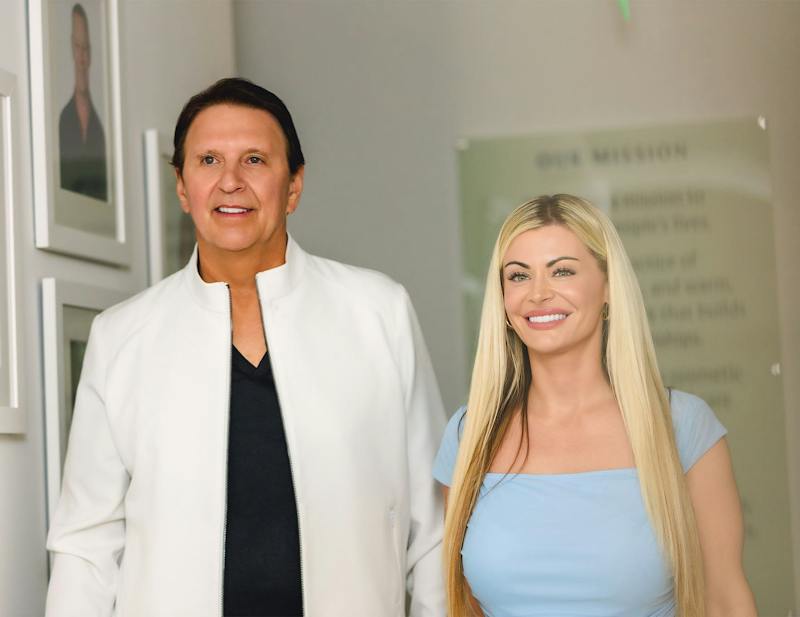 John and female patient smiling