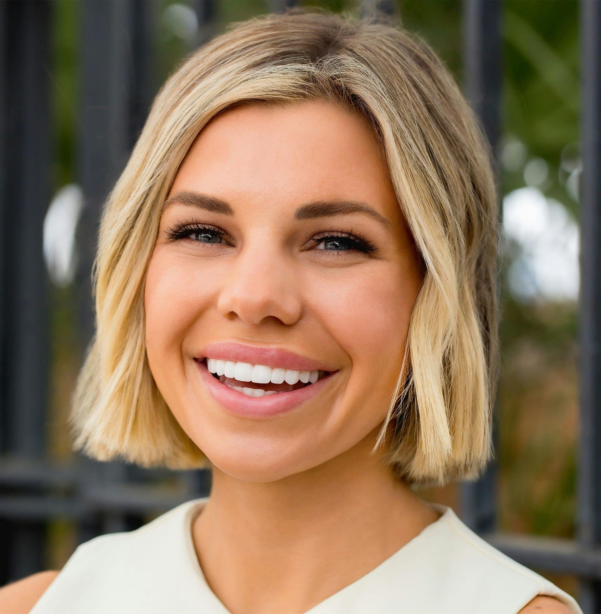 woman with short blonde hair smiling