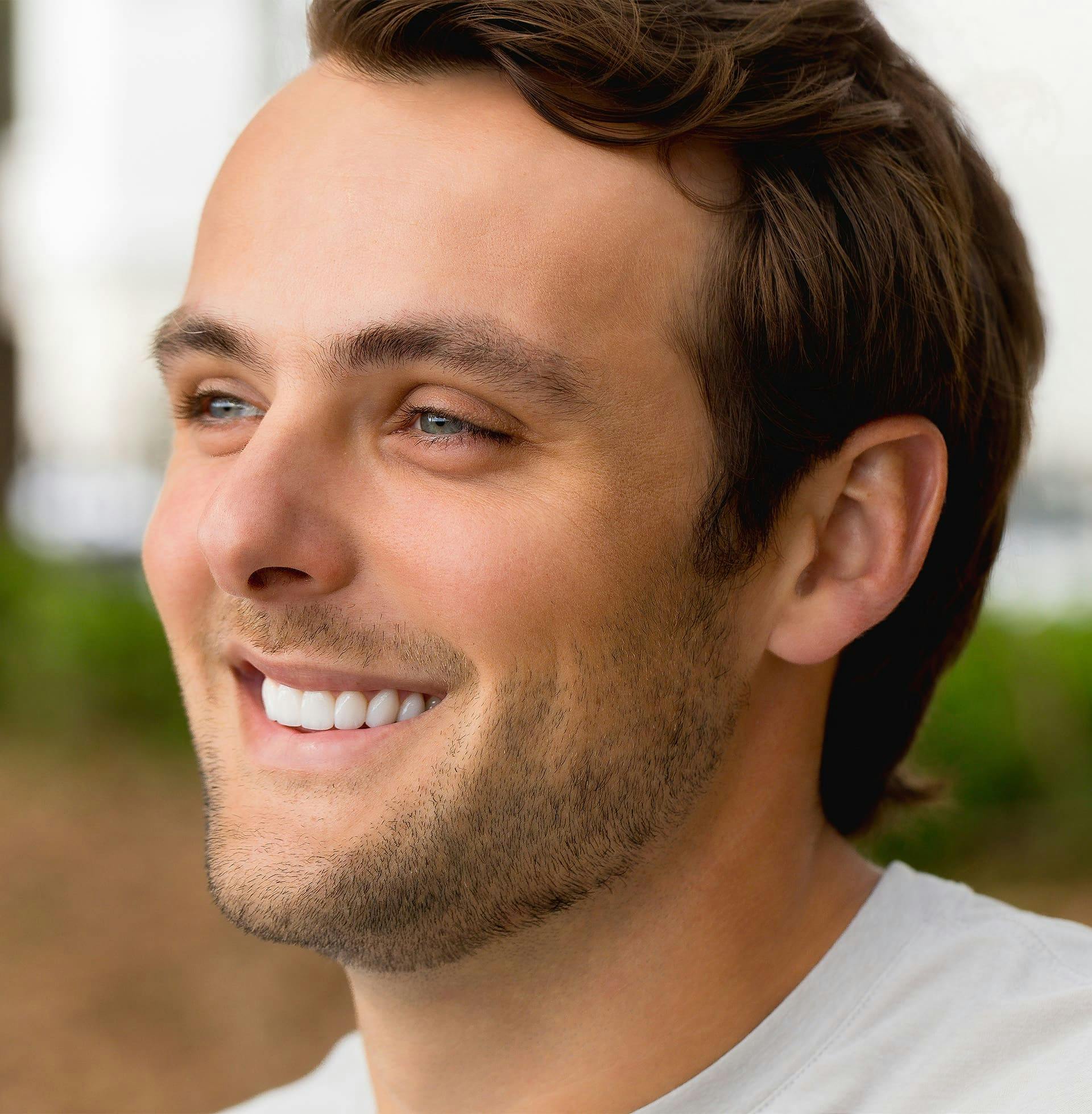 man smiling and looking off to the side