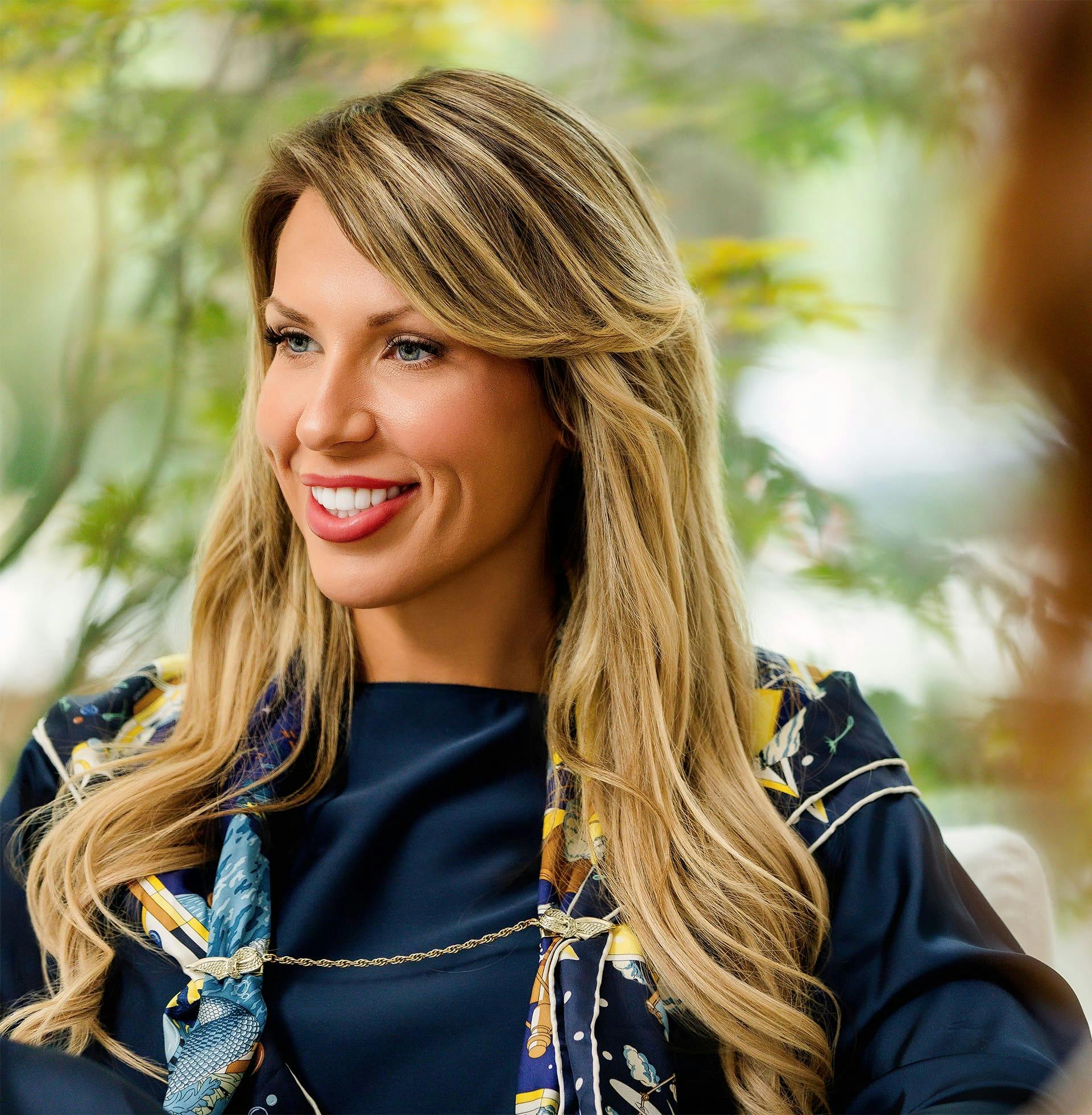 woman sitting down and smiling