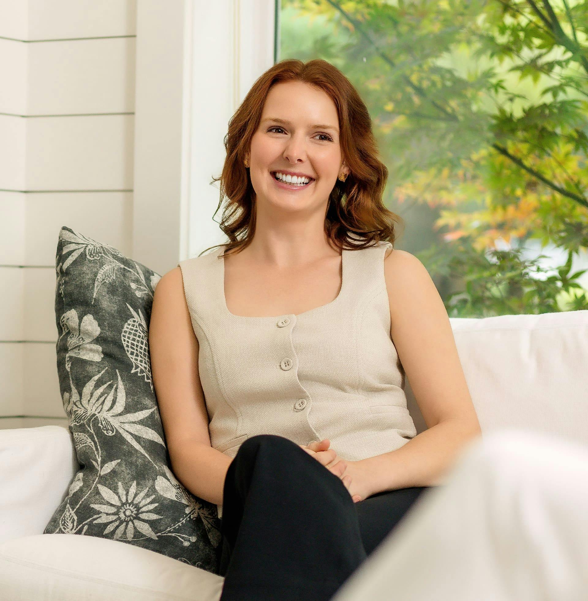 woman sitting on couch smiling