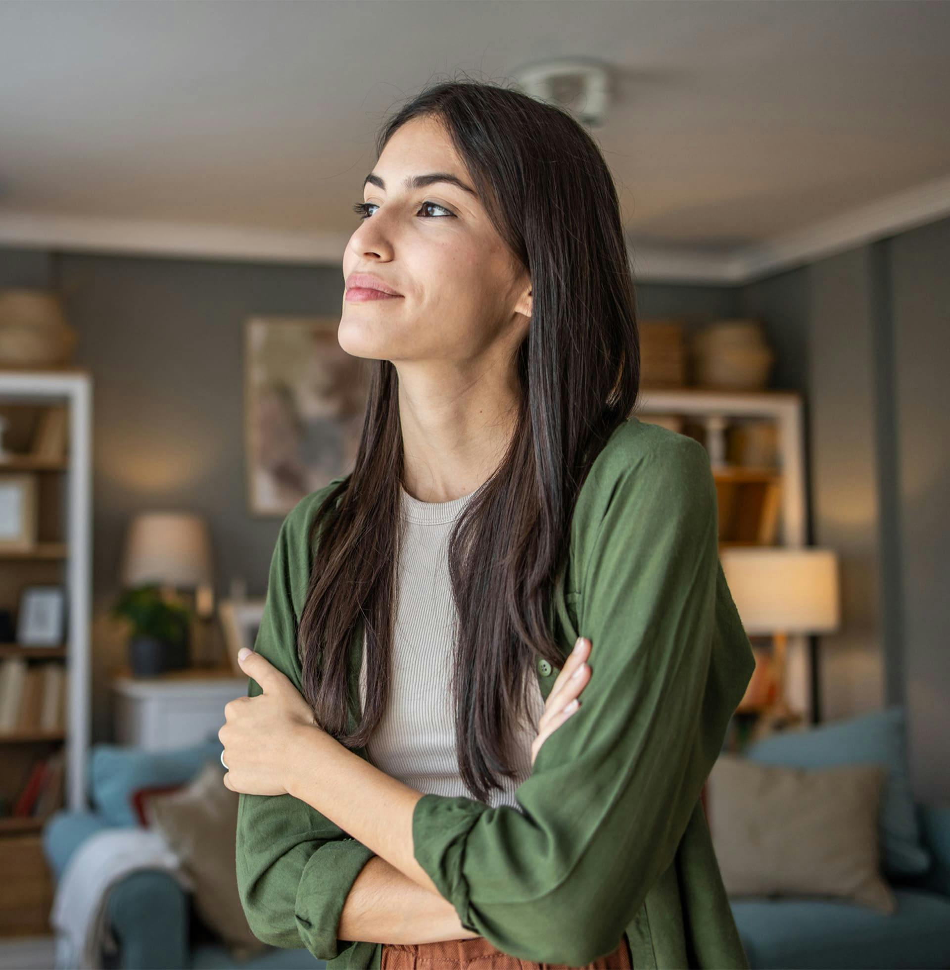 woman looking to the left while crossing her arms