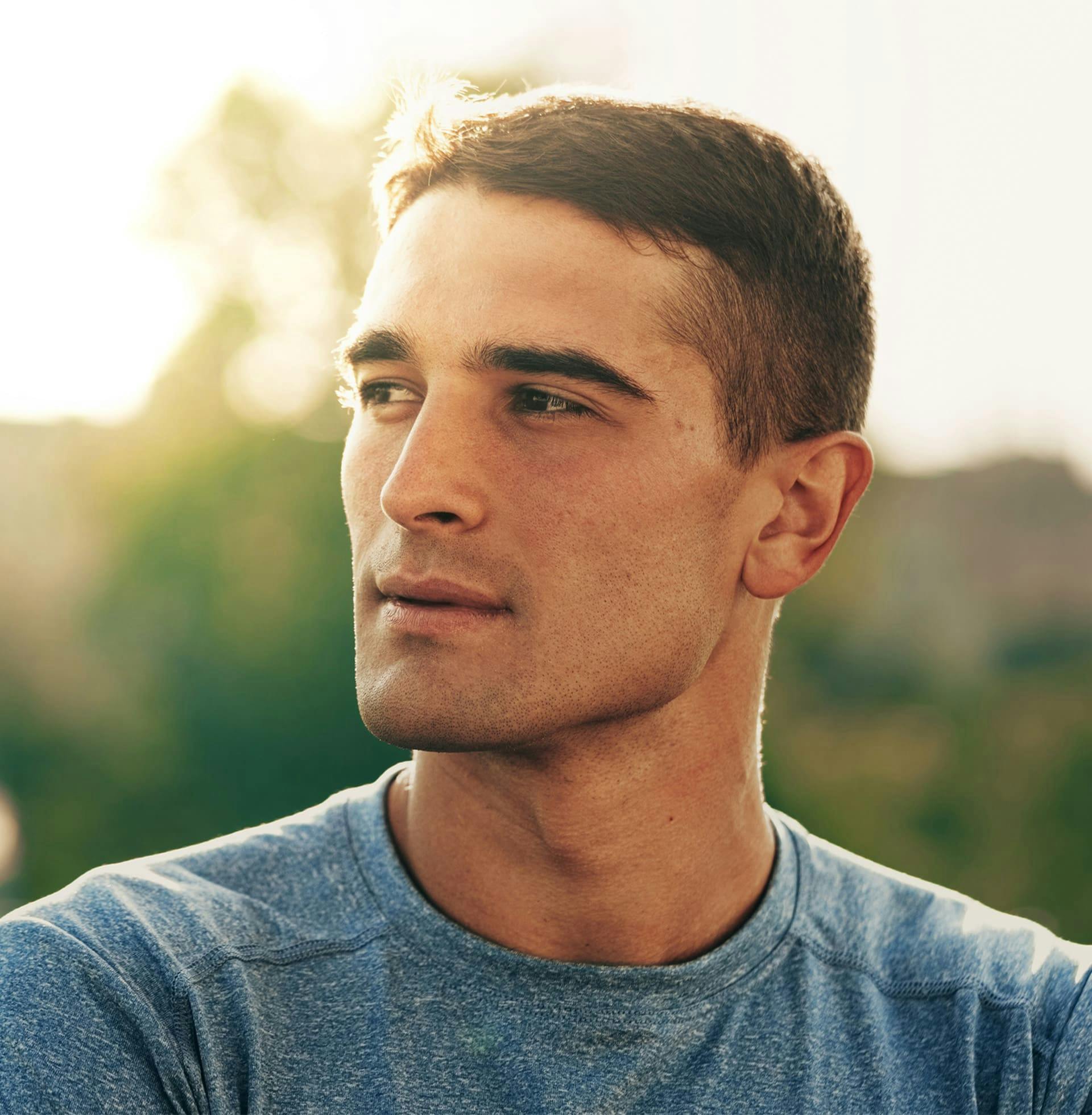 man outside looking to left