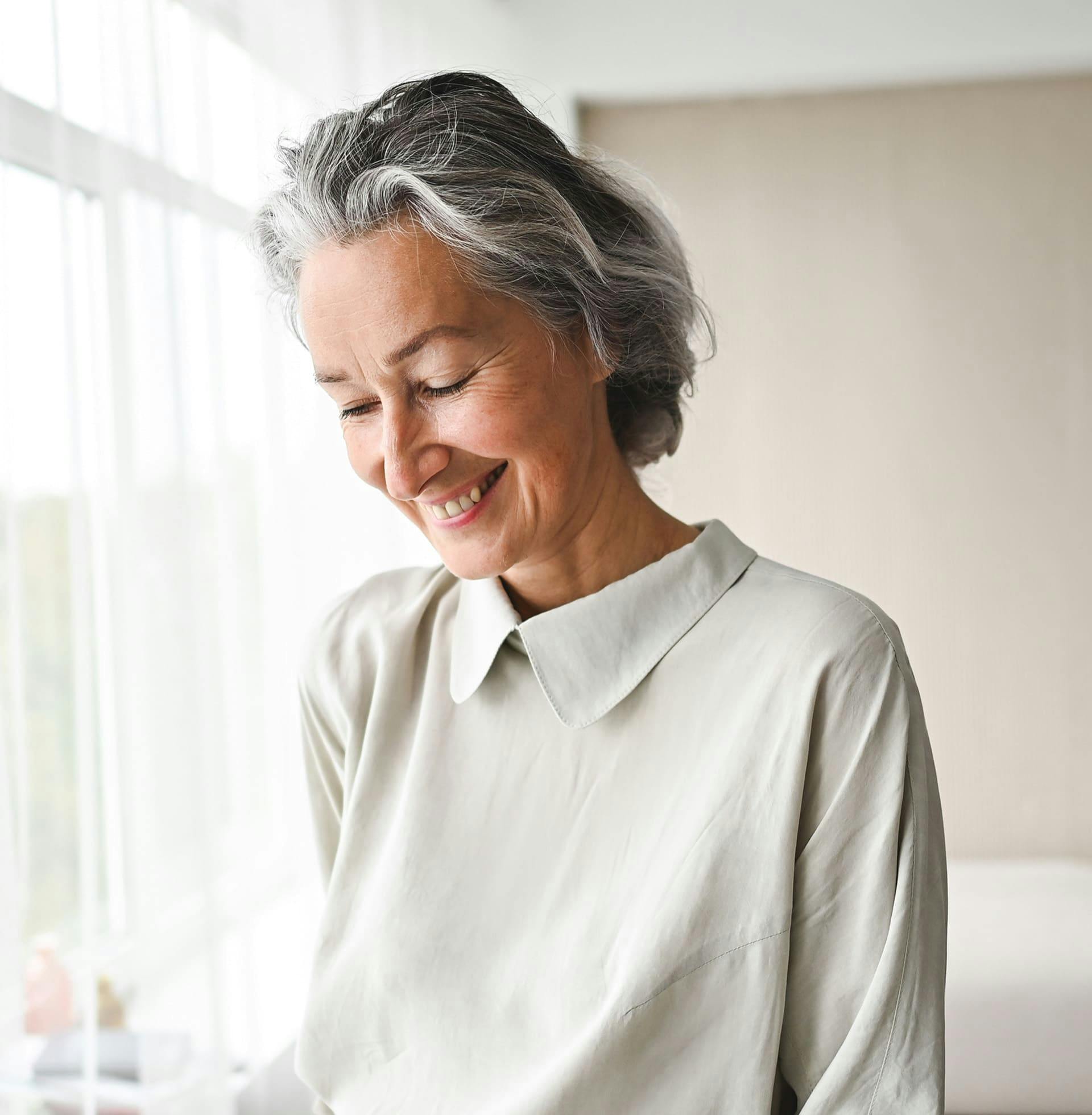older woman smiling and looking down