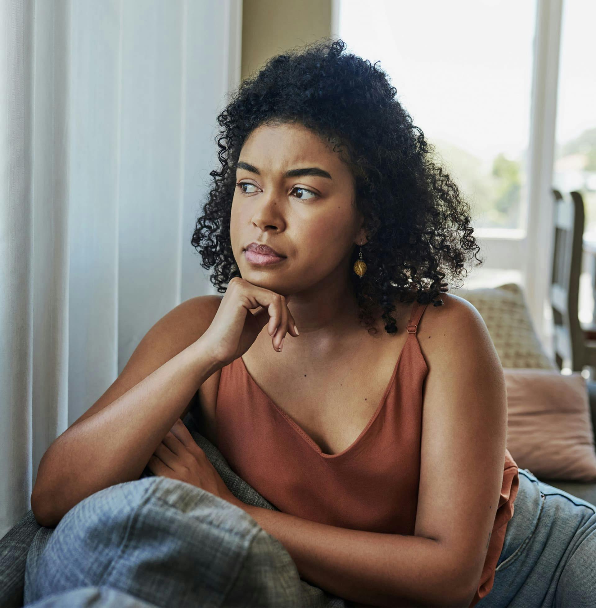 woman sitting on couch visibly upset