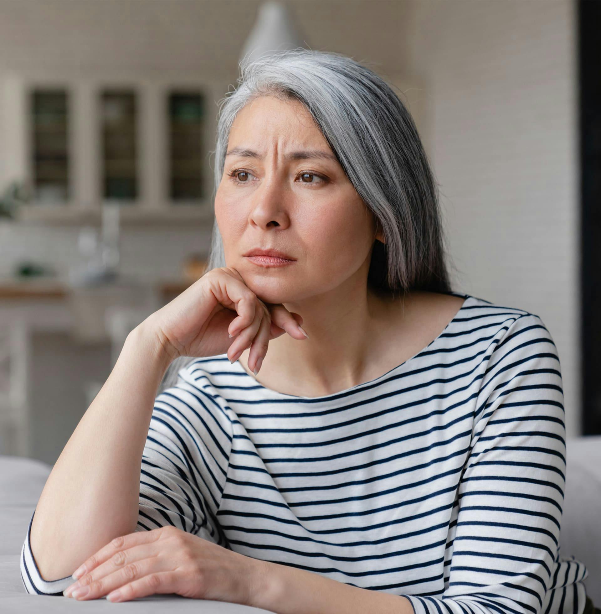 woman at table showing concern