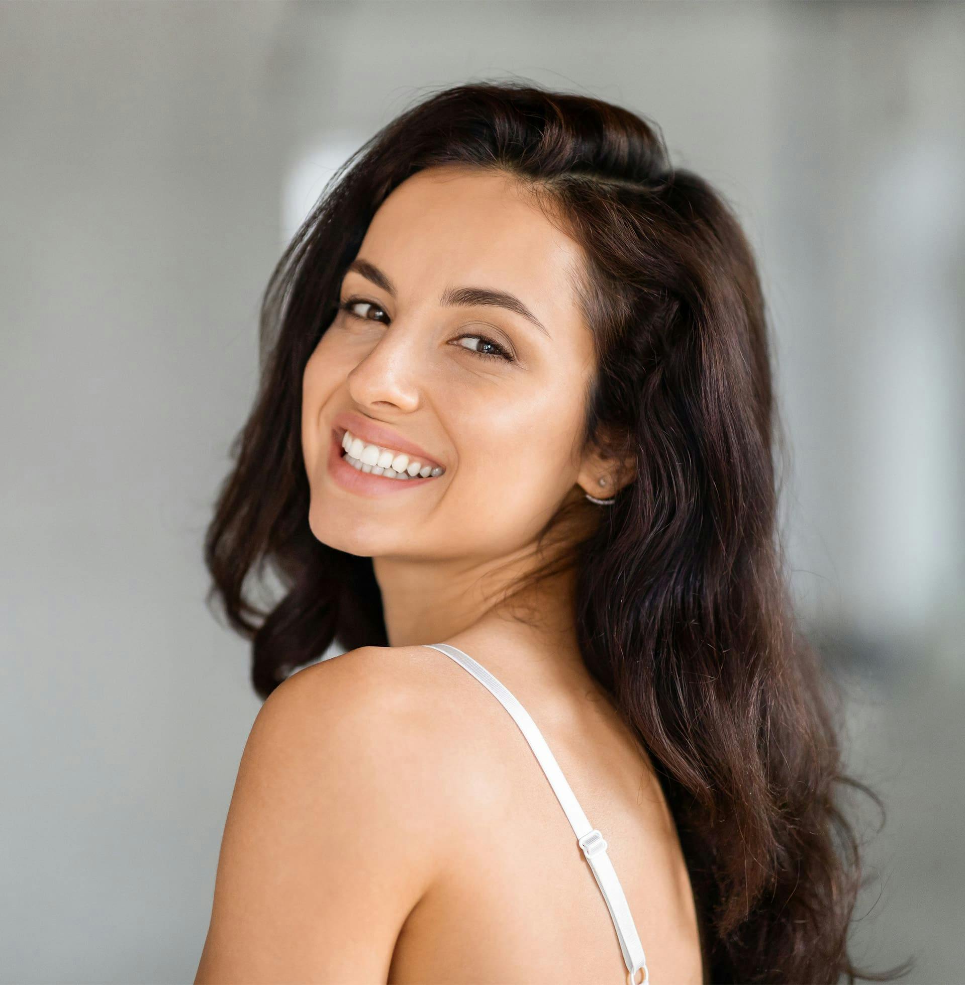 woman smilling over her shoulder