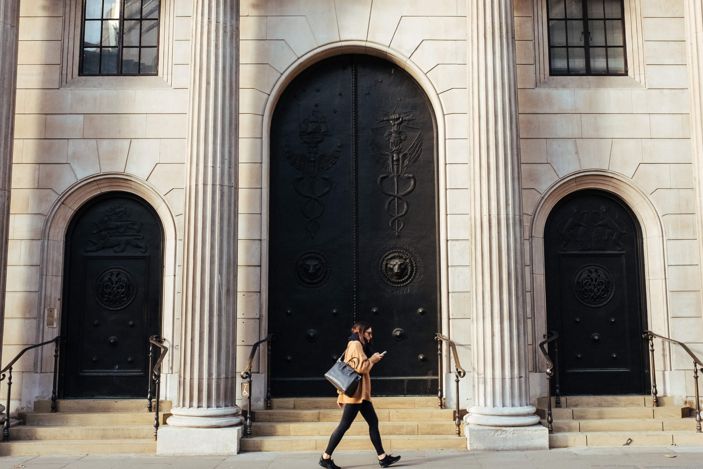 A woman walking in front of a bank
