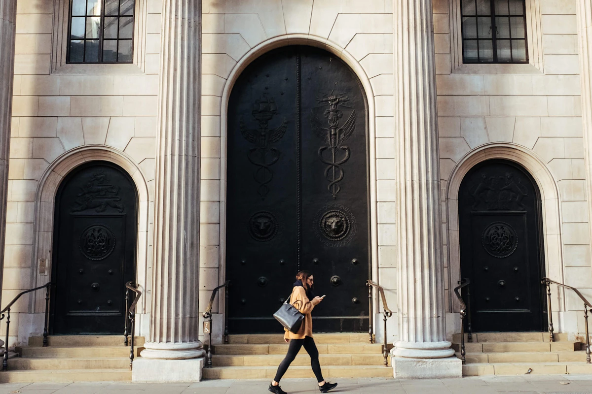A woman walking in front of a bank