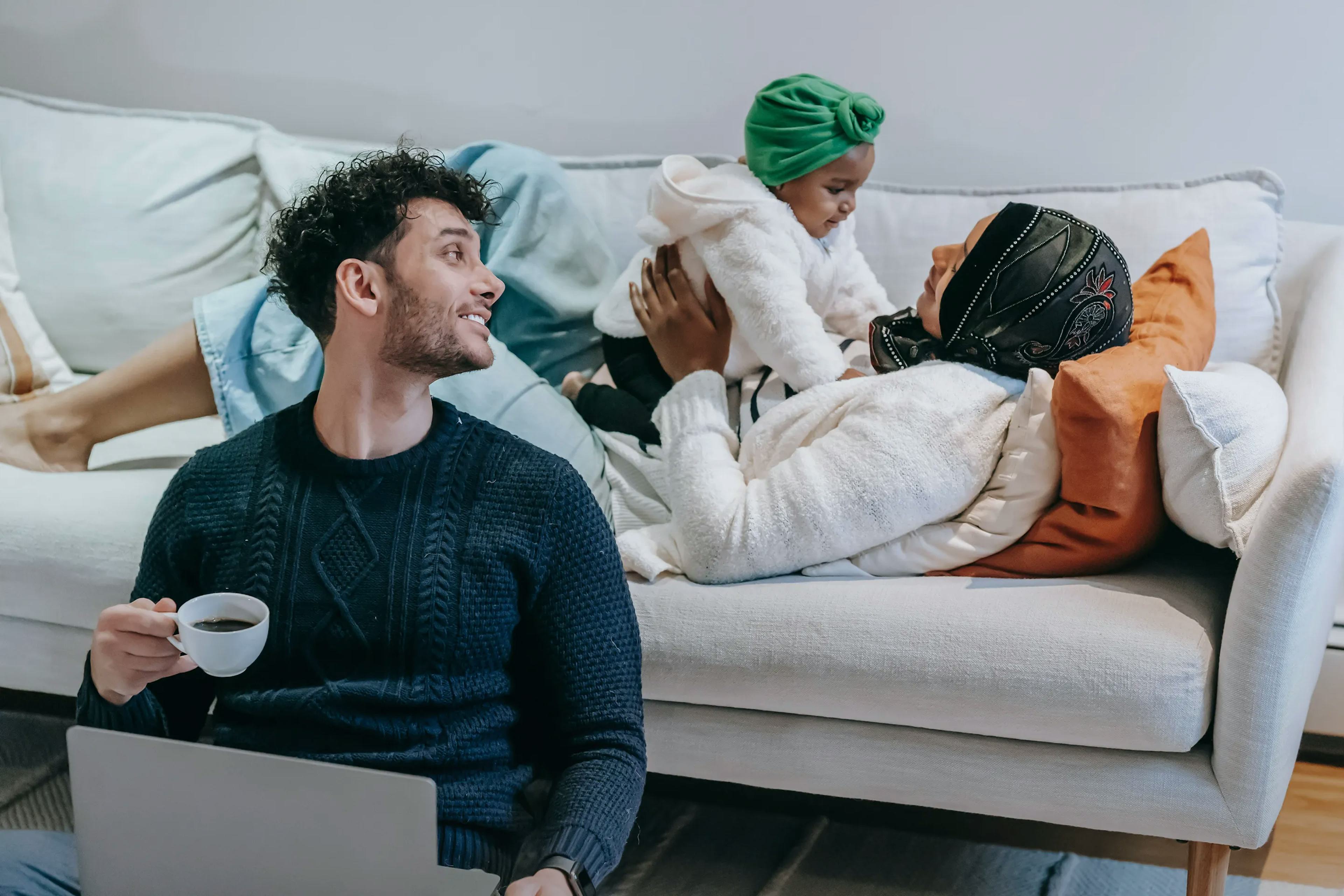 Photo of a happy couple with a child in a living space