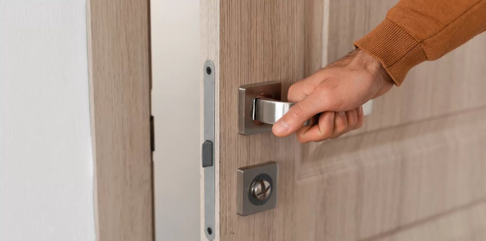 Man touching a door handle