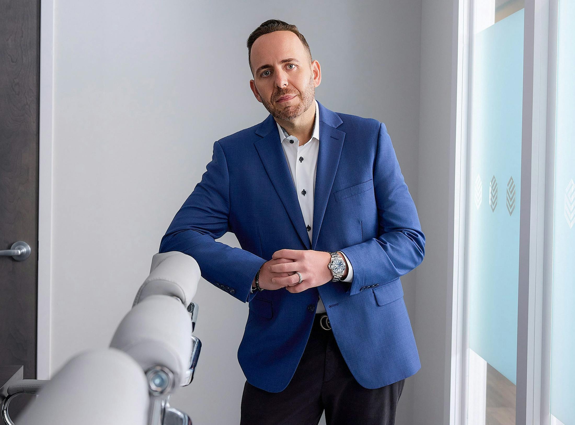 Marc H. Schneider leaning on chair