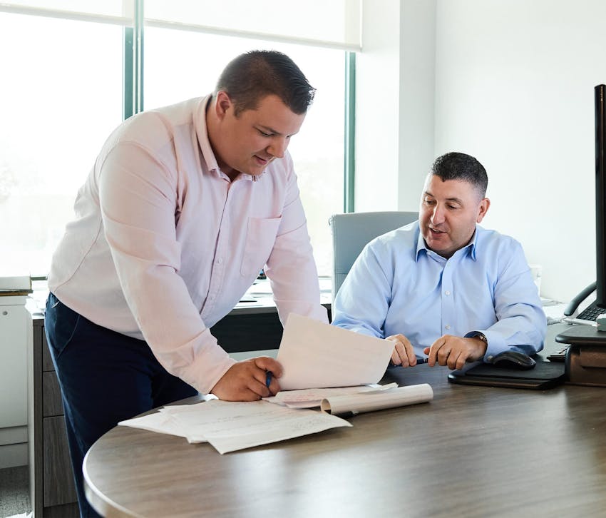 two people looking at paperwork
