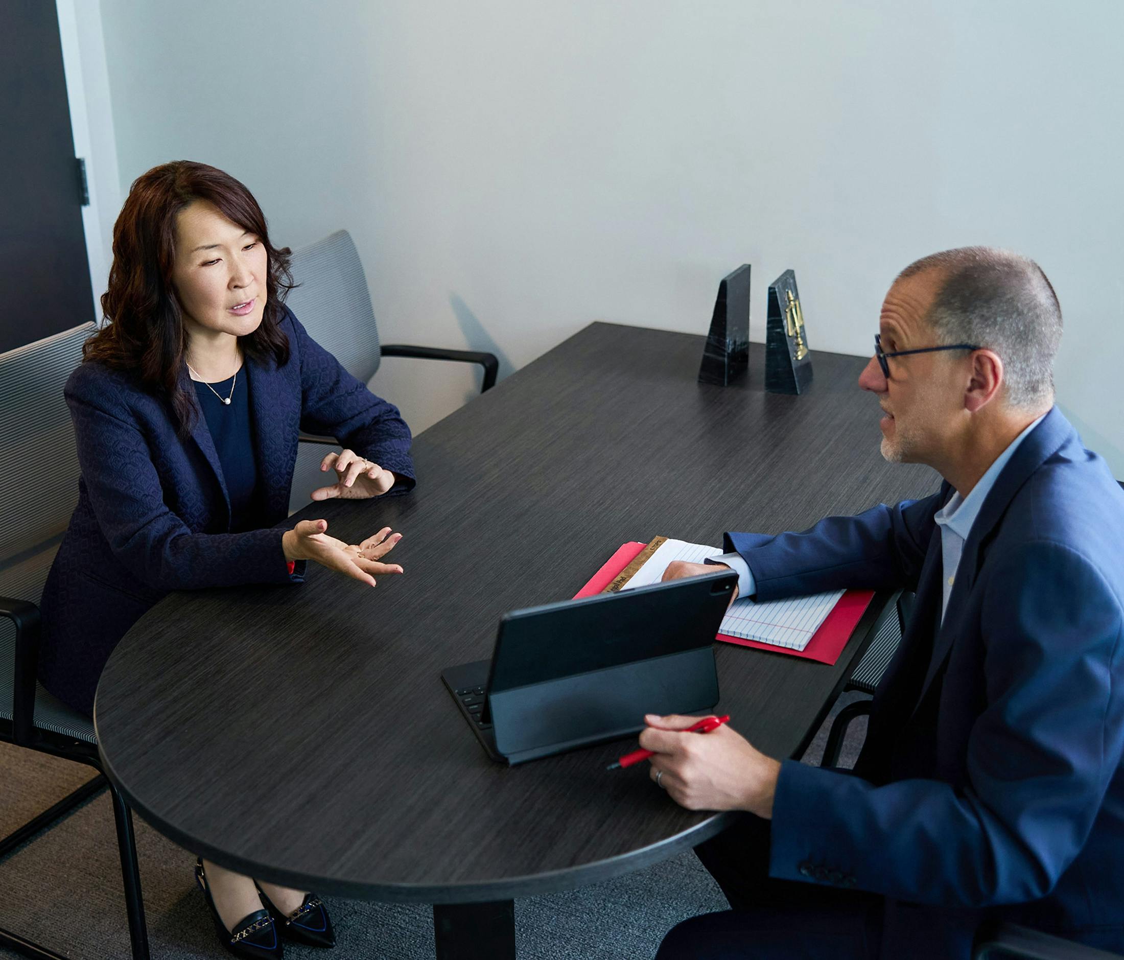 two people talking over an ipad