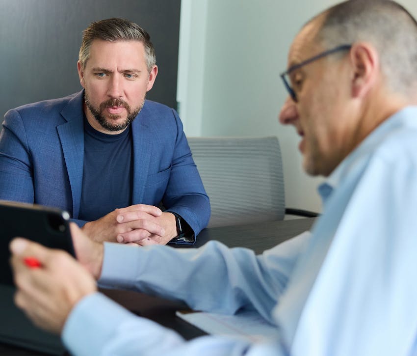 two people looking at a laptop