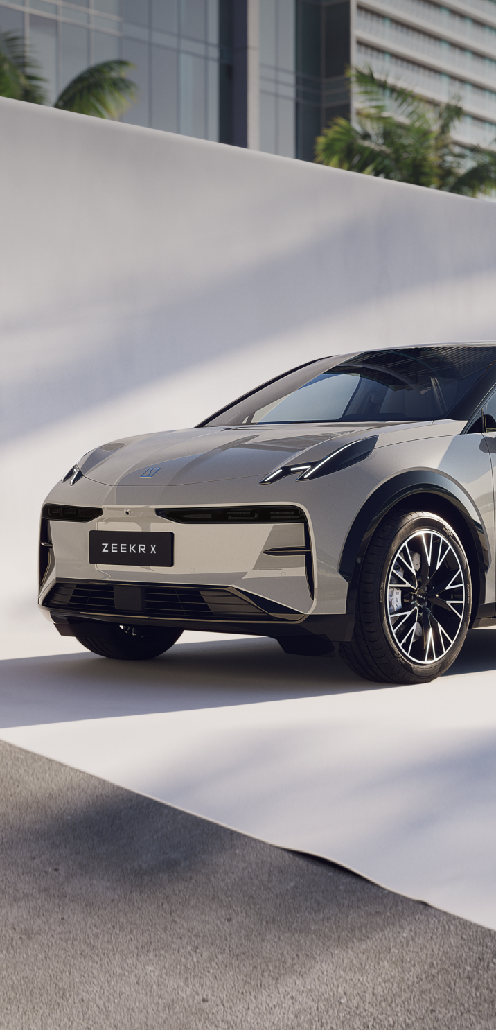 Front-side view of the Zeekr X AWD electric car in Palace Beige, showcasing its sleek European design, aerodynamic body, and modern urban setting.