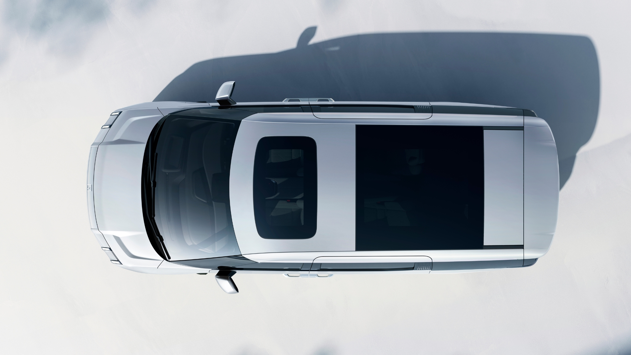 Top-down view of the Zeekr 009 showcasing the panoramic fixed glass roof with power shades, offering a bright and spacious cabin.