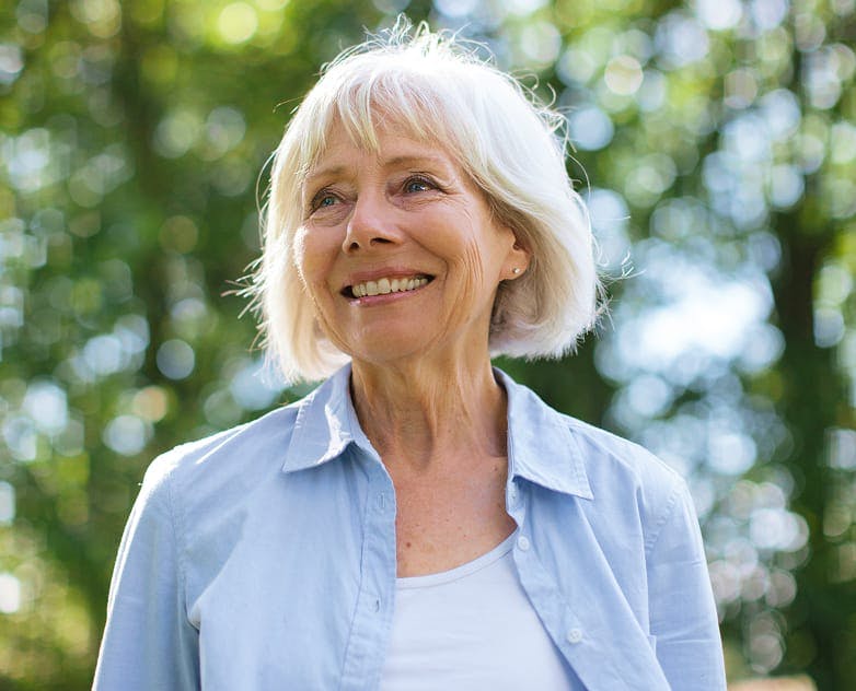 older woman smiling outside