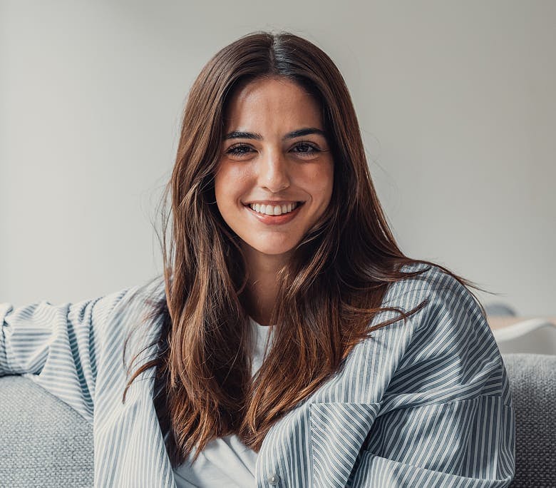 woman sitting on couch smiling