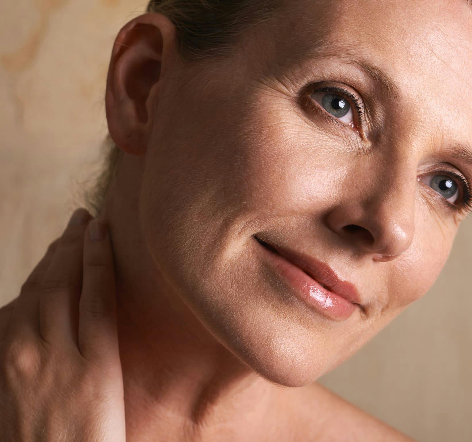 close up on woman touching the side of her neck