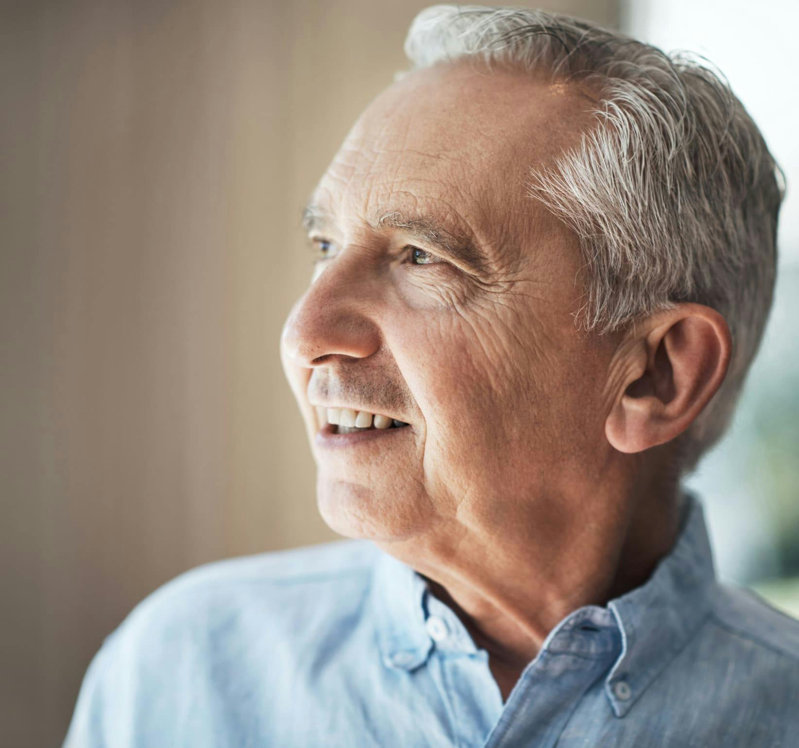 older man smiling and looking to the left