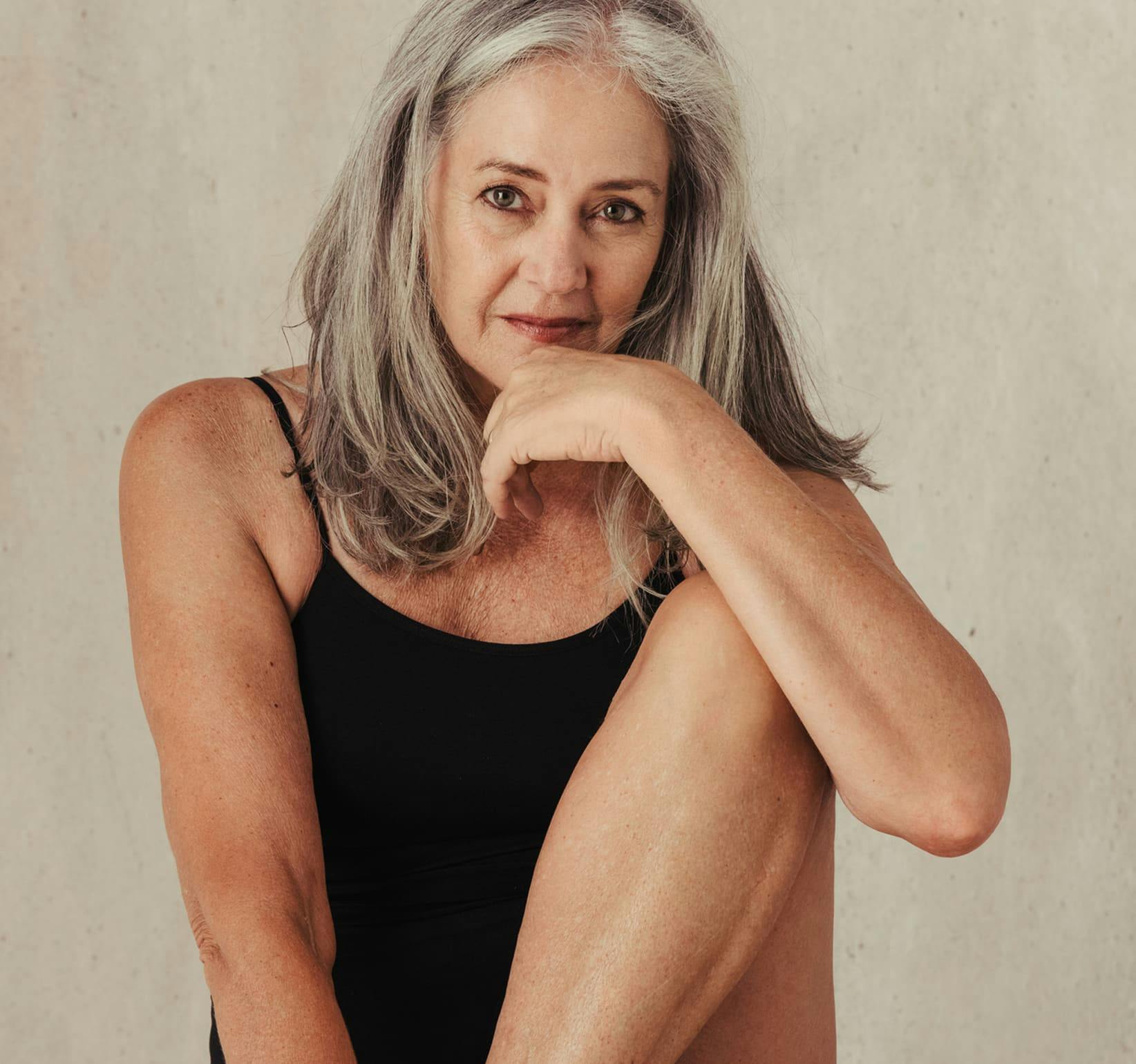 older woman sitting with her knee propped up