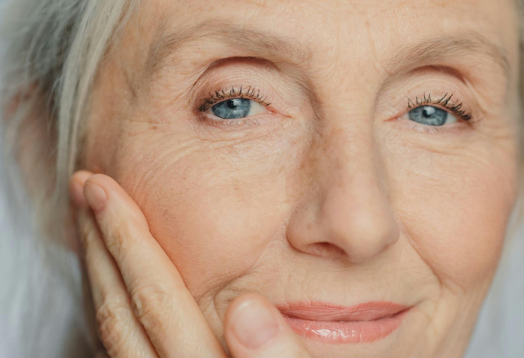 close up on older woman's face with bright blue eyes