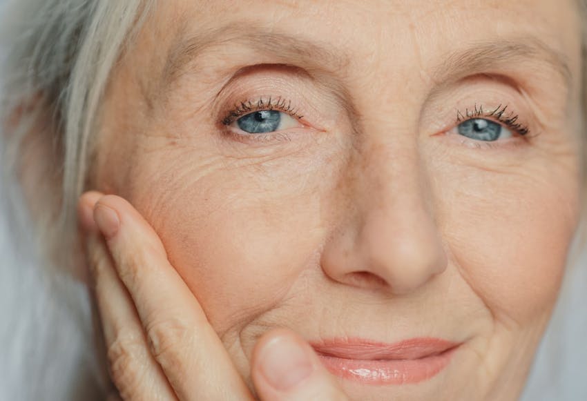 close up on older woman's face with bright blue eyes
