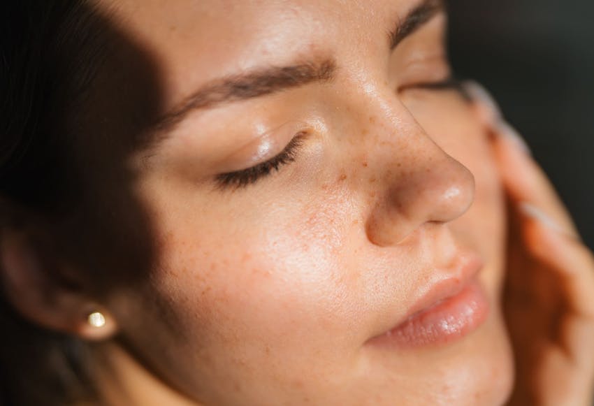 close up on woman's face with the sunlight hitting it