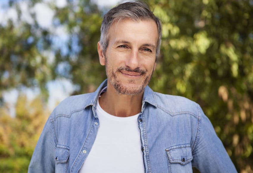 man outside smiling in jean jacket